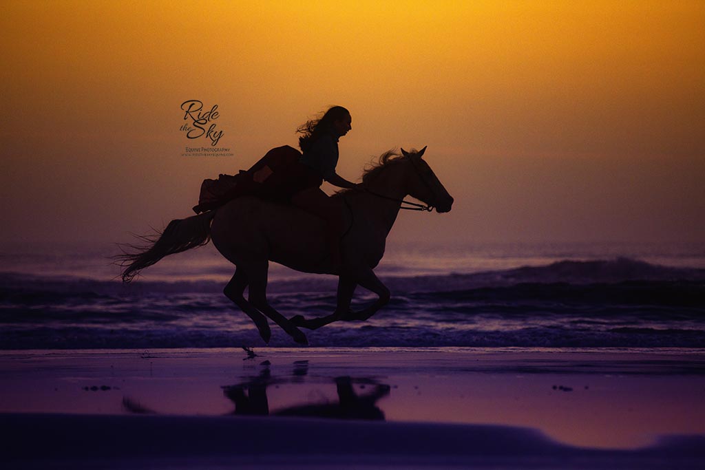 Girl riding horse on the beach captured at a horse photography workshop