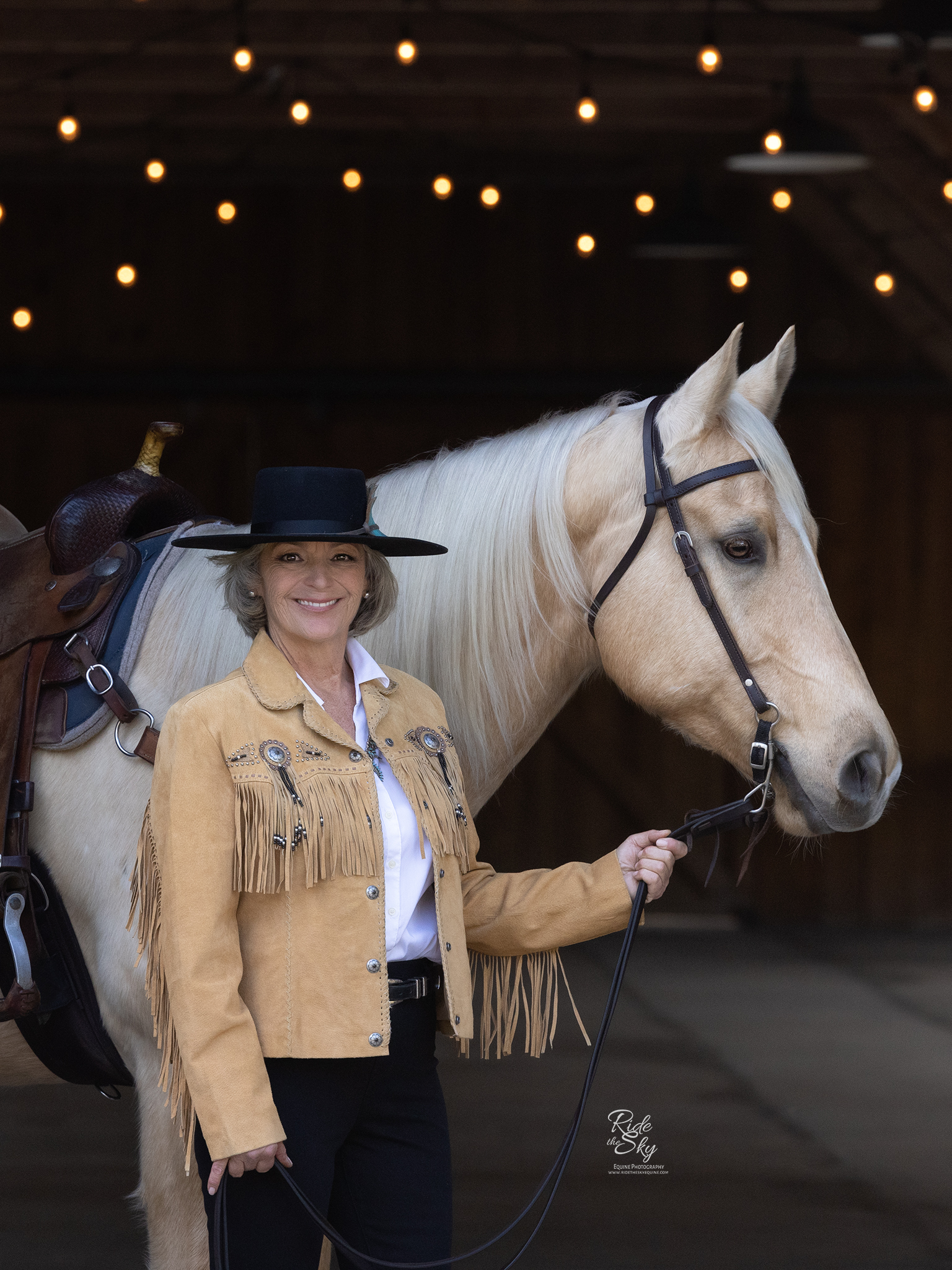 Portrait of middle aged Woman with her palomino horse