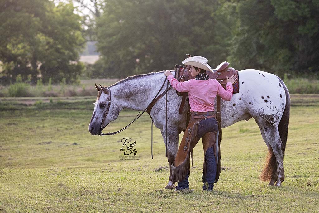 Cowgirl and Appaloosa Horse in field