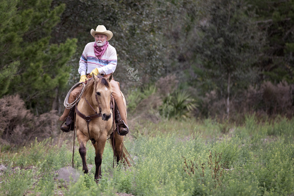 Florida Cracker Cowboy and his horse in the field