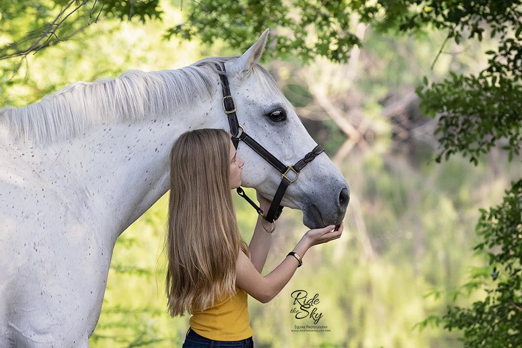 Girl with Gray Horse touching muzzle