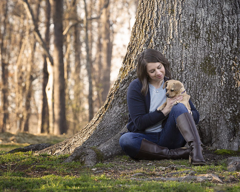 Woman and dog sitting next to tree at Enterprise South Nature Park in Chattanooga