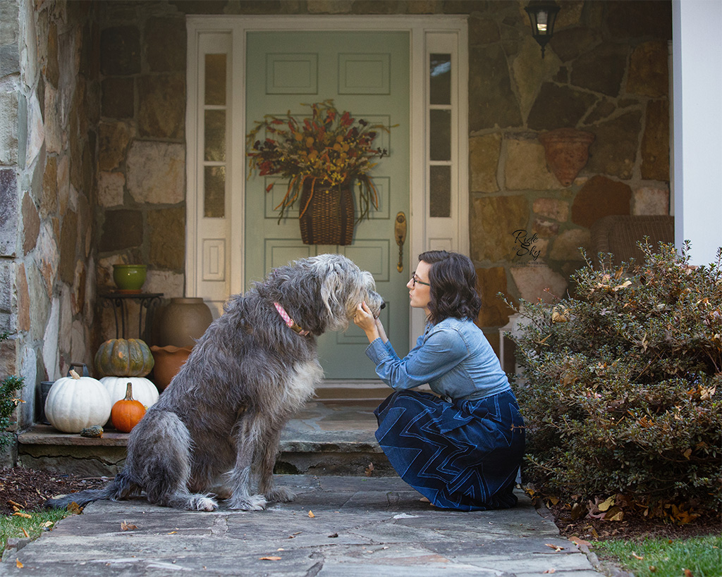 Woman and Dog in front of House