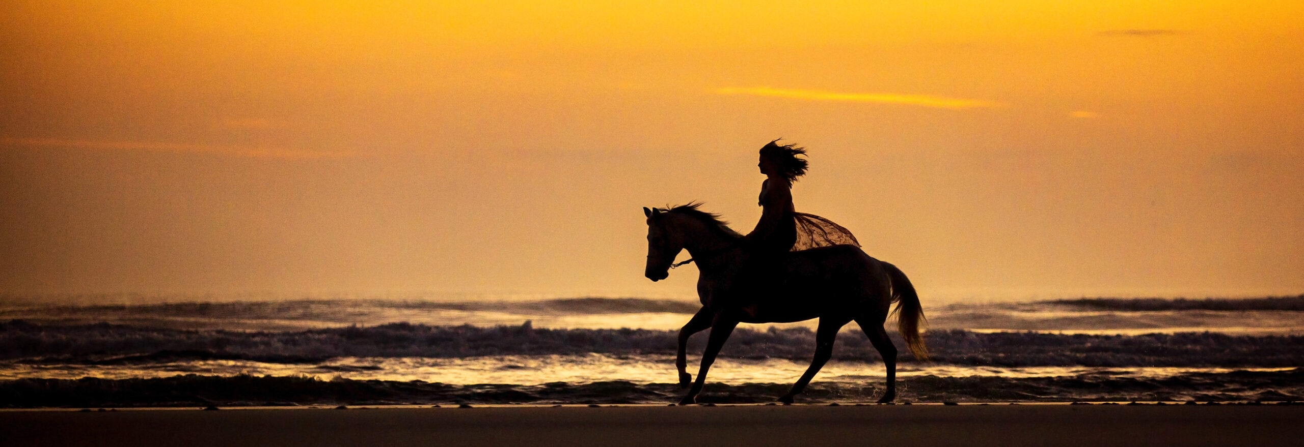 Woman-Horse-Sunrise-Beach-RidetheSkyEquine Woman Riding Horse on Beach at Sunrise