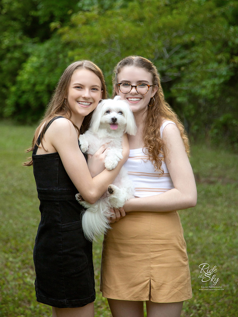 Teen Girls holding white dog in Enterprise South nature park
