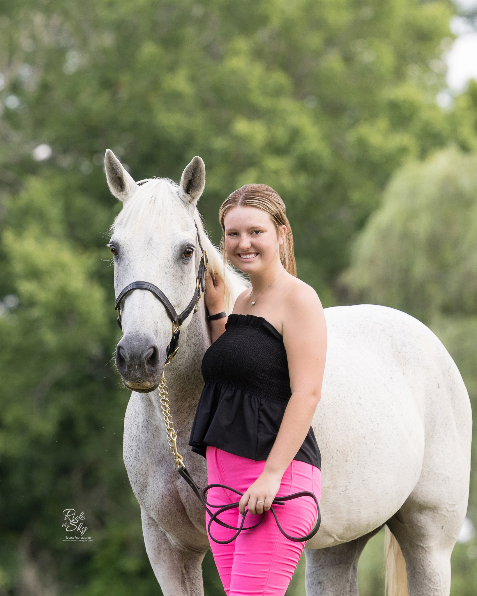 High School Senior Girl with her gray lesson horse during her senior pictures in Dalton Georgia