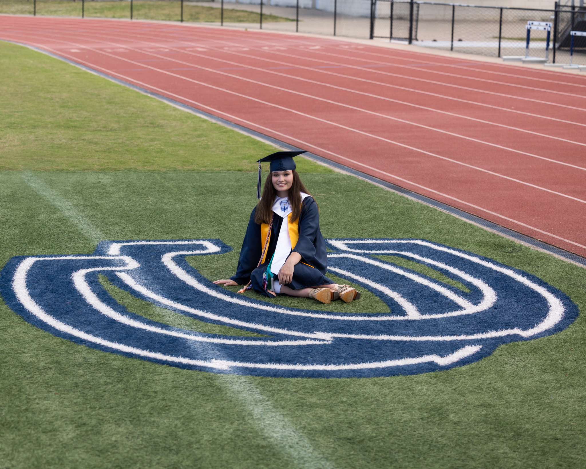 High School Senior photographed on the football field in her high school stadium