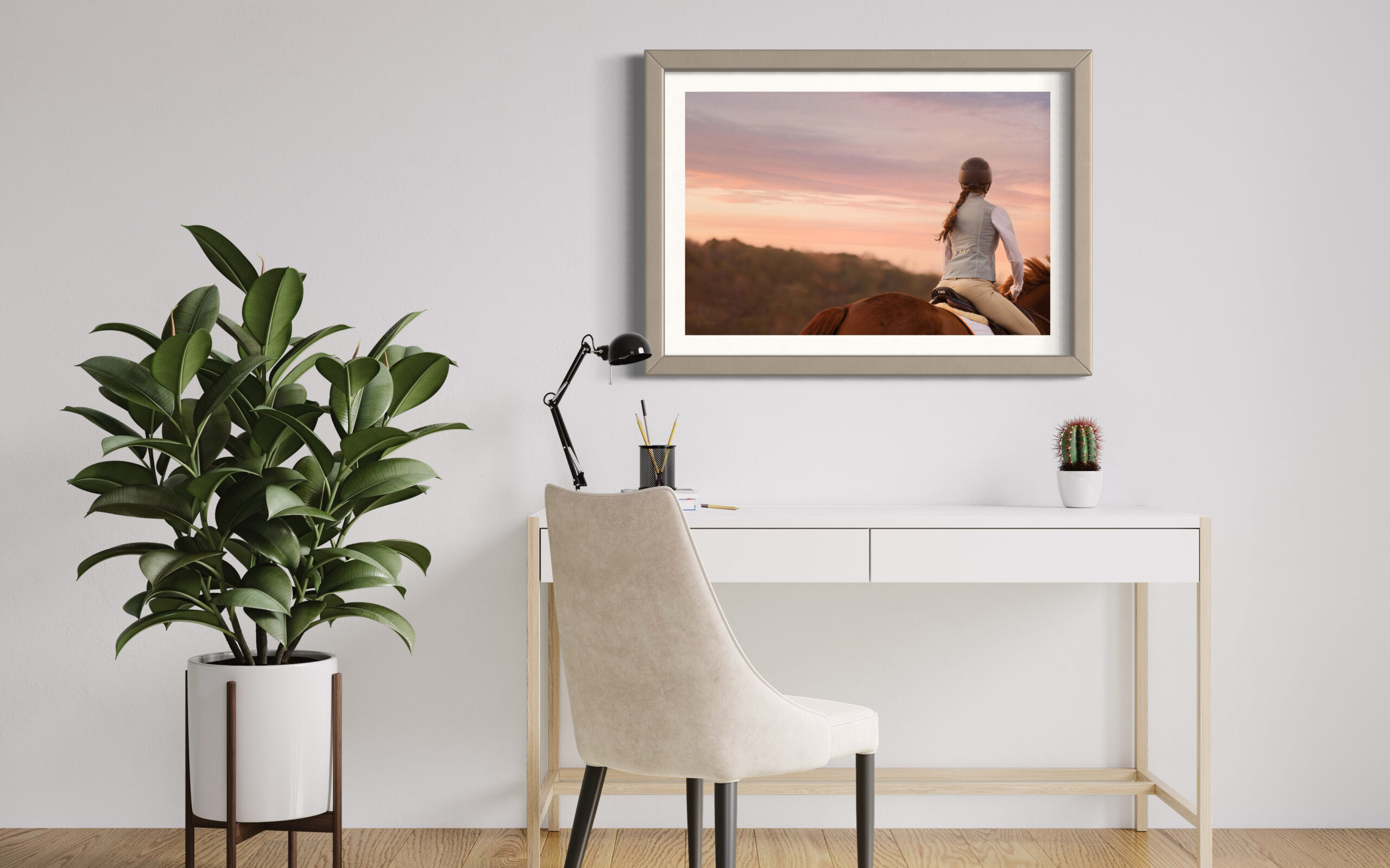 Equestrian Wall Art of woman riding horse at sunset with a pink sky.